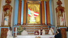 The Father Symbol at the Patroness' feet