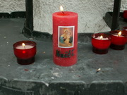Candle lit at the Original Shrine for Haiti