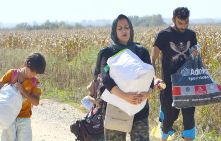 Sid, Serbia - September 18th, 2015: Syrian family walking on the dirt road, preparing to cross the border between Serbia and Croatia, looking for a new life. Mother, father and the son, going to a better future in the EU countries.