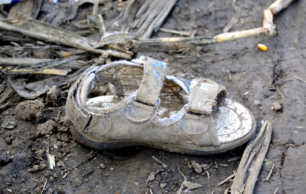 Sid, Serbia - October 2nd, 2015: Child shoe lost by Syrian refugees on their way to European Union States, on a dirt path near the Serbia - Croatia border.