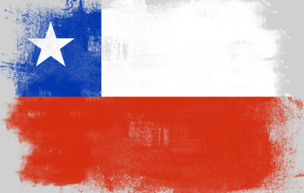 Flag of Chile painted with brush on solid background,